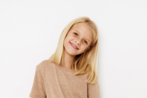 Child smiling before an early orthodontic evaluation in Greensboro, NC